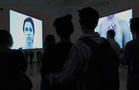 Shrouds, 2012--view of the exhibition at BWA Zielona Gora. Two suspended screens with projections visible on both sides, sound composition.